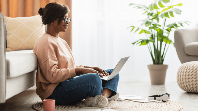 mother sitting on floor looking for a new school online