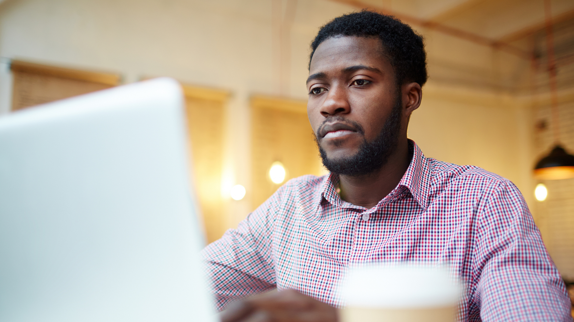 guy sitting at computer writing for a school blog