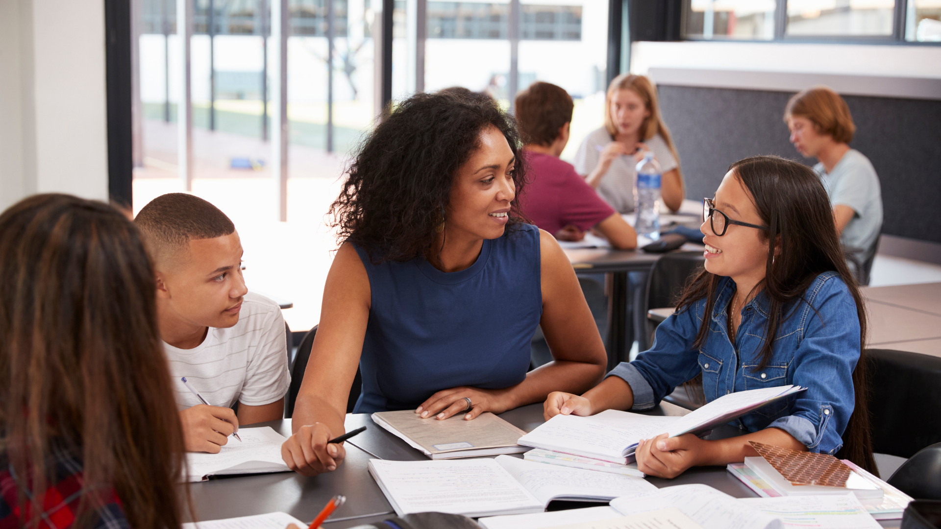 teacher-studying-school-books-in-class-with-high-s-2021-08-26-16-14-01-utc