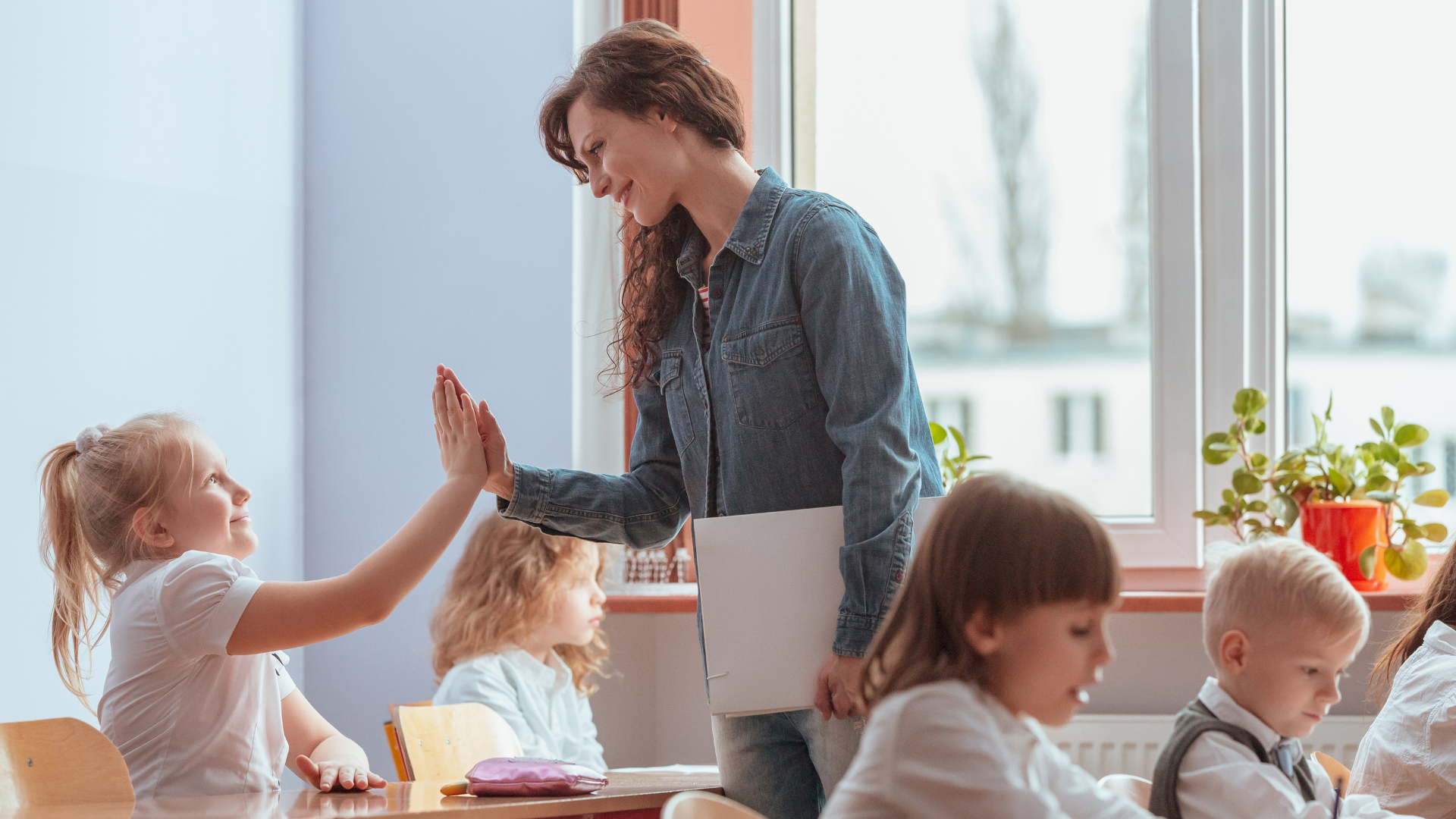 young-teacher-gives-a-high-five-to-the-student-2021-08-31-08-36-09-utc