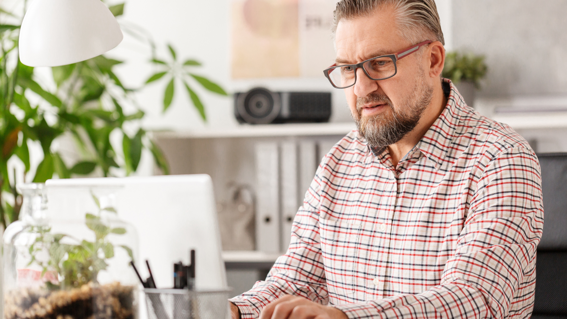 frustrated man sitting at computer