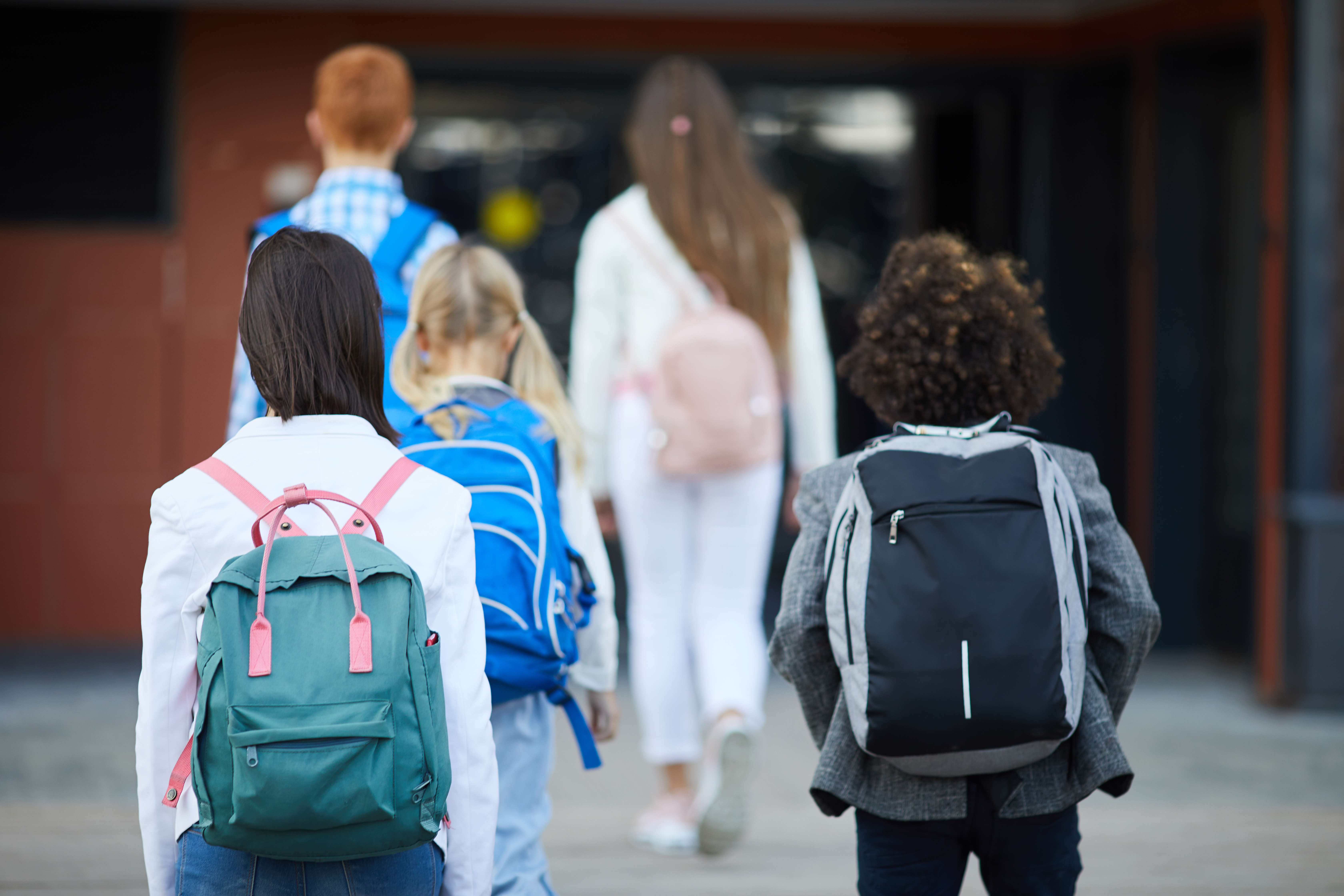 a group of school kids walking toward school
